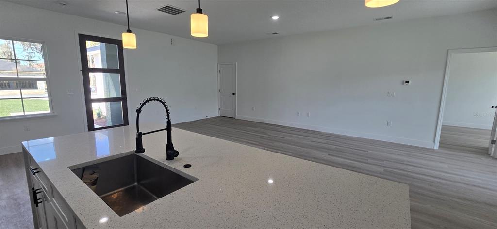 4464 Southwest 132nd Street Ocala, FL 34473 - Photo 6 of 17 a kitchen with a sink and a refrigerator