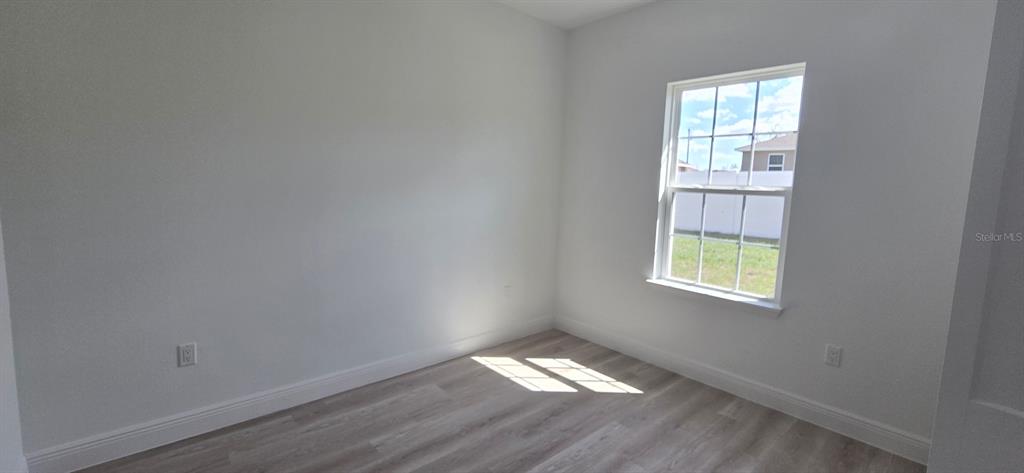 4464 Southwest 132nd Street Ocala, FL 34473 - Photo 7 of 17 an empty room with a window