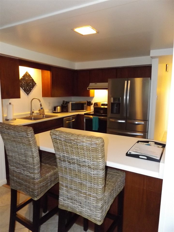 811 South Kihei Road, Unit 5F Kihei, HI 96753 - Photo 5 of 30 a kitchen with granite countertop a sink and a stove