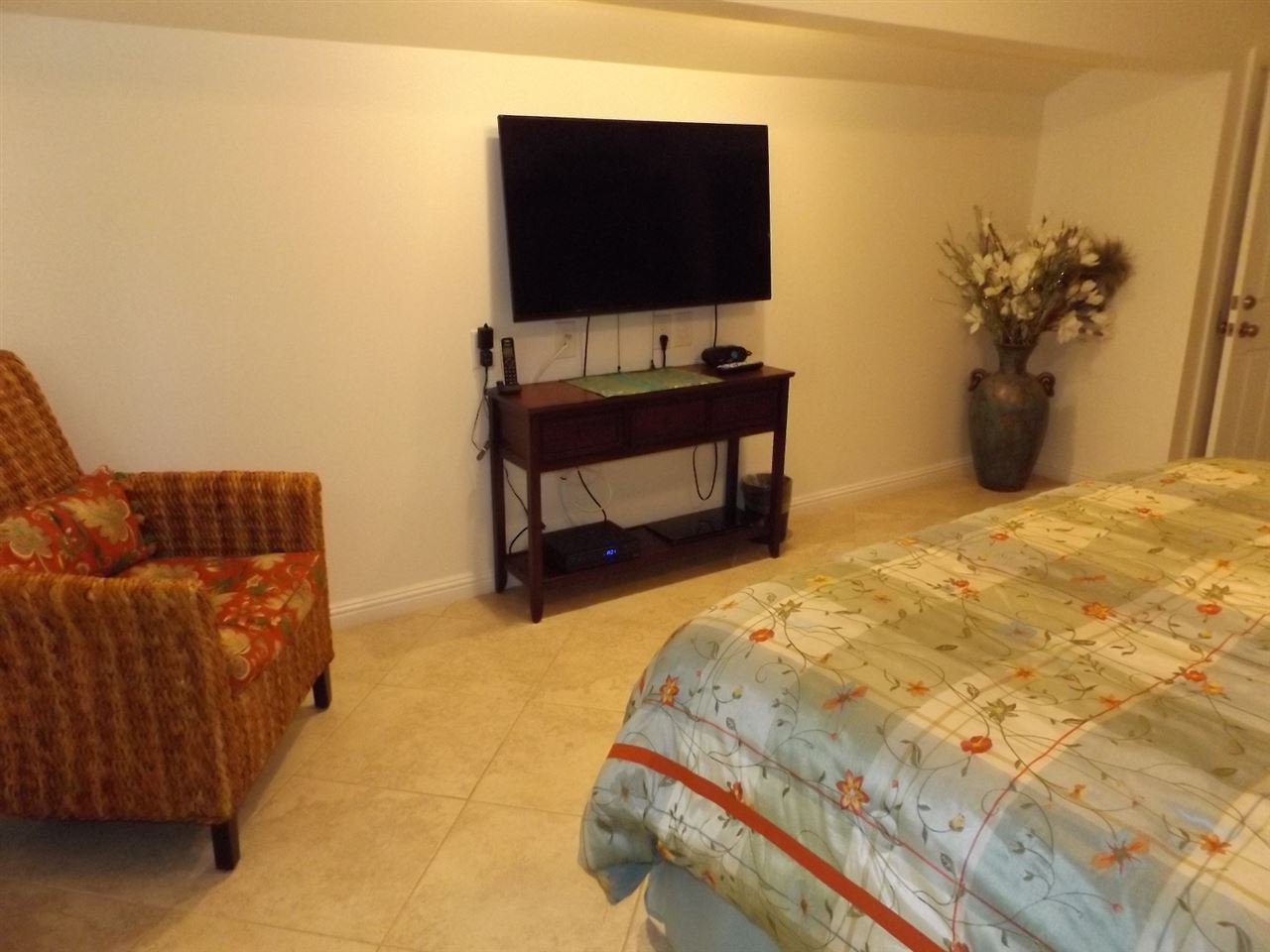 811 South Kihei Road, Unit 5F Kihei, HI 96753 - Photo 8 of 30 a bedroom with a bed and a flat screen tv