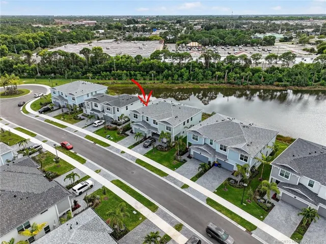 a front view of a house with garden and sitting area