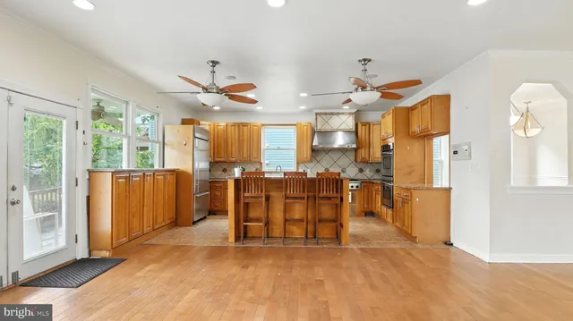 a view of a kitchen with furniture and a large window