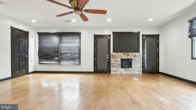 a view of a kitchen with a sink and a refrigerator a ceiling fan