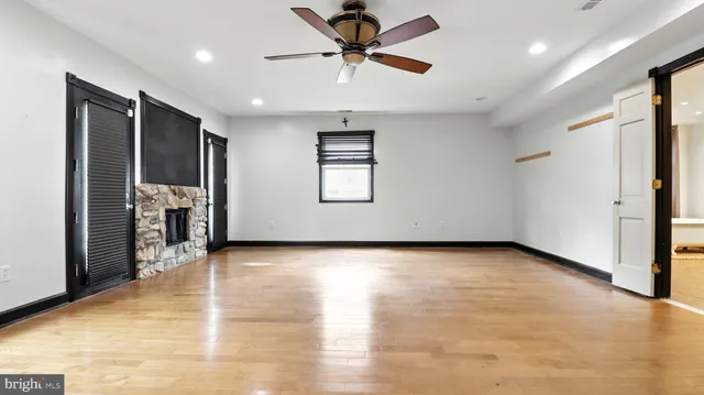 a view of a livingroom with a ceiling fan and window