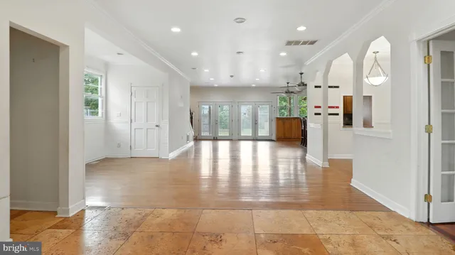 a view of a big room with windows and chandelier