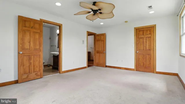a view of empty room with ceiling fan
