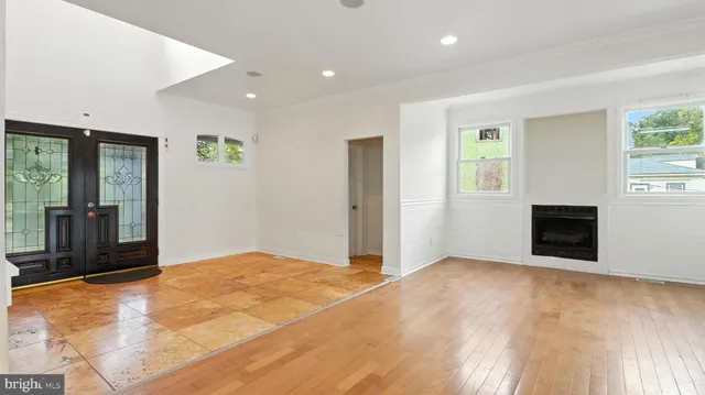 a view of an empty room with a fireplace and a window