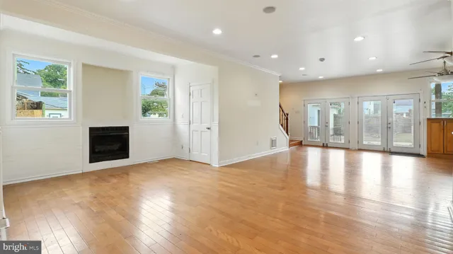 a view of empty room with wooden floor and fireplace