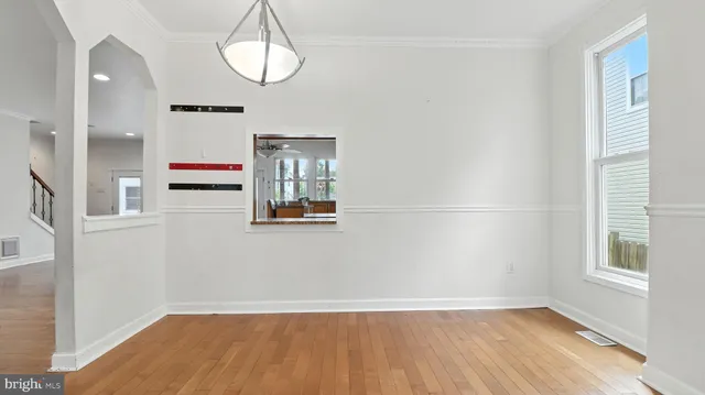 a view of a livingroom with wooden floor and window