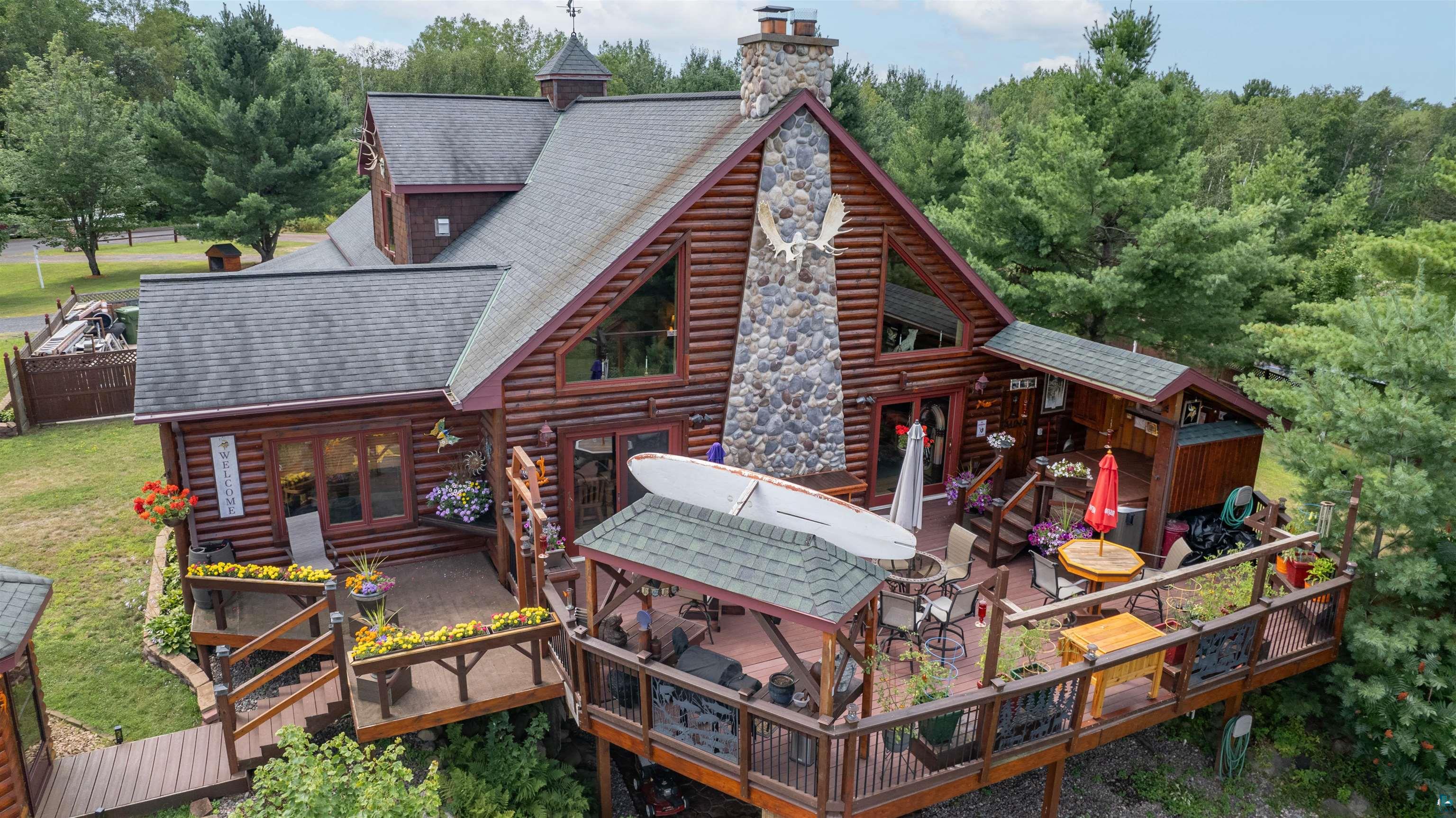 Expansive multi-level wood deck with integrated planters and a covered patio area