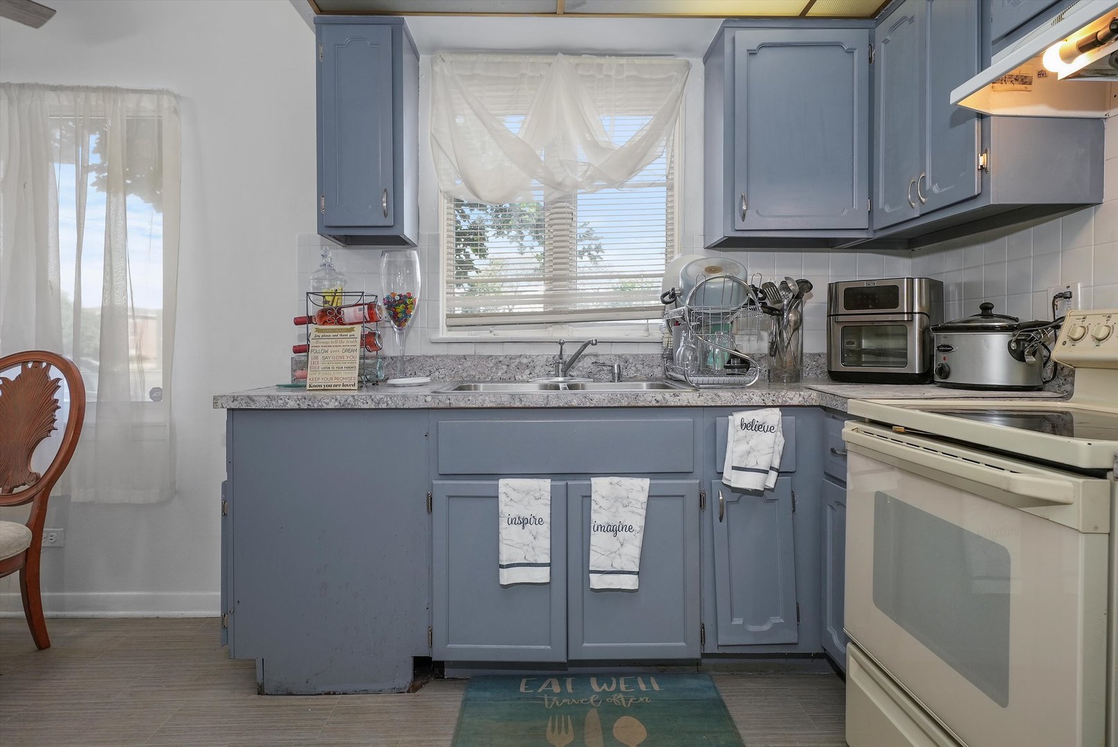 10340 South Pulaski Road, Unit 103 Oak Lawn, IL 60453 - Photo 15 of 30 a kitchen with stainless steel appliances granite countertop a sink stove and cabinets
