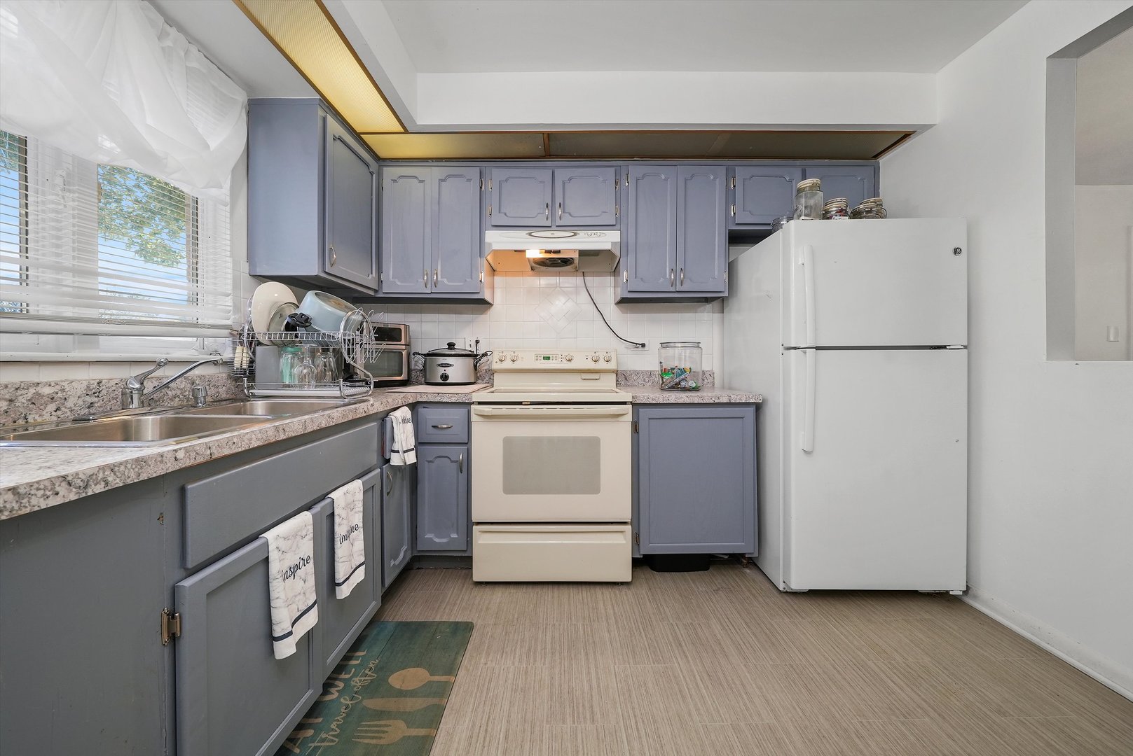 10340 South Pulaski Road, Unit 103 Oak Lawn, IL 60453 - Photo 16 of 30 a kitchen with a white cabinets and white appliances