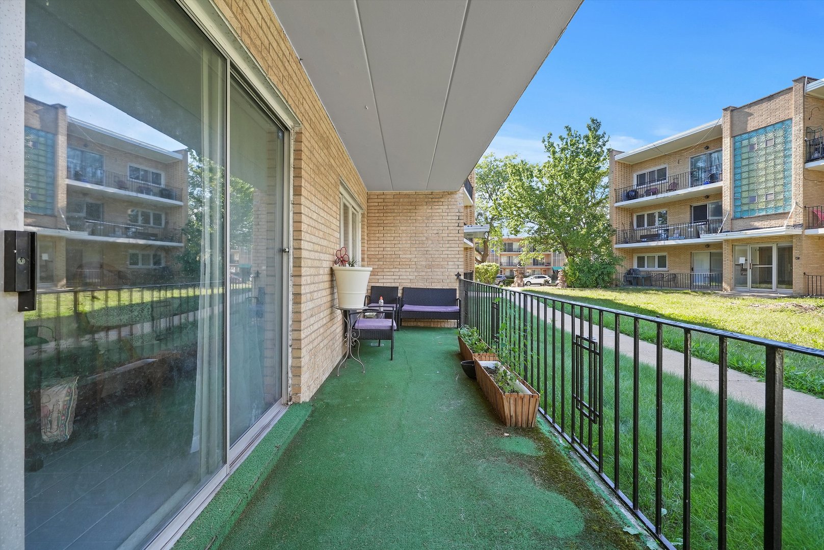 10340 South Pulaski Road, Unit 103 Oak Lawn, IL 60453 - Photo 18 of 30 a view of a porch with a floor to ceiling window and wooden fence
