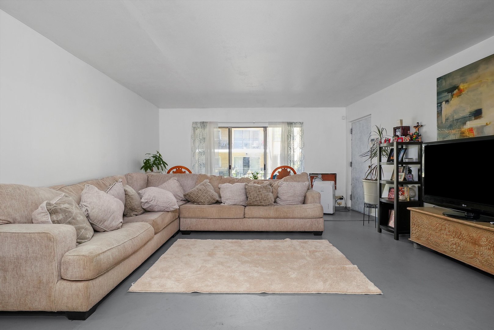 10340 South Pulaski Road, Unit 103 Oak Lawn, IL 60453 - Photo 2 of 30 a living room with furniture and a flat screen tv