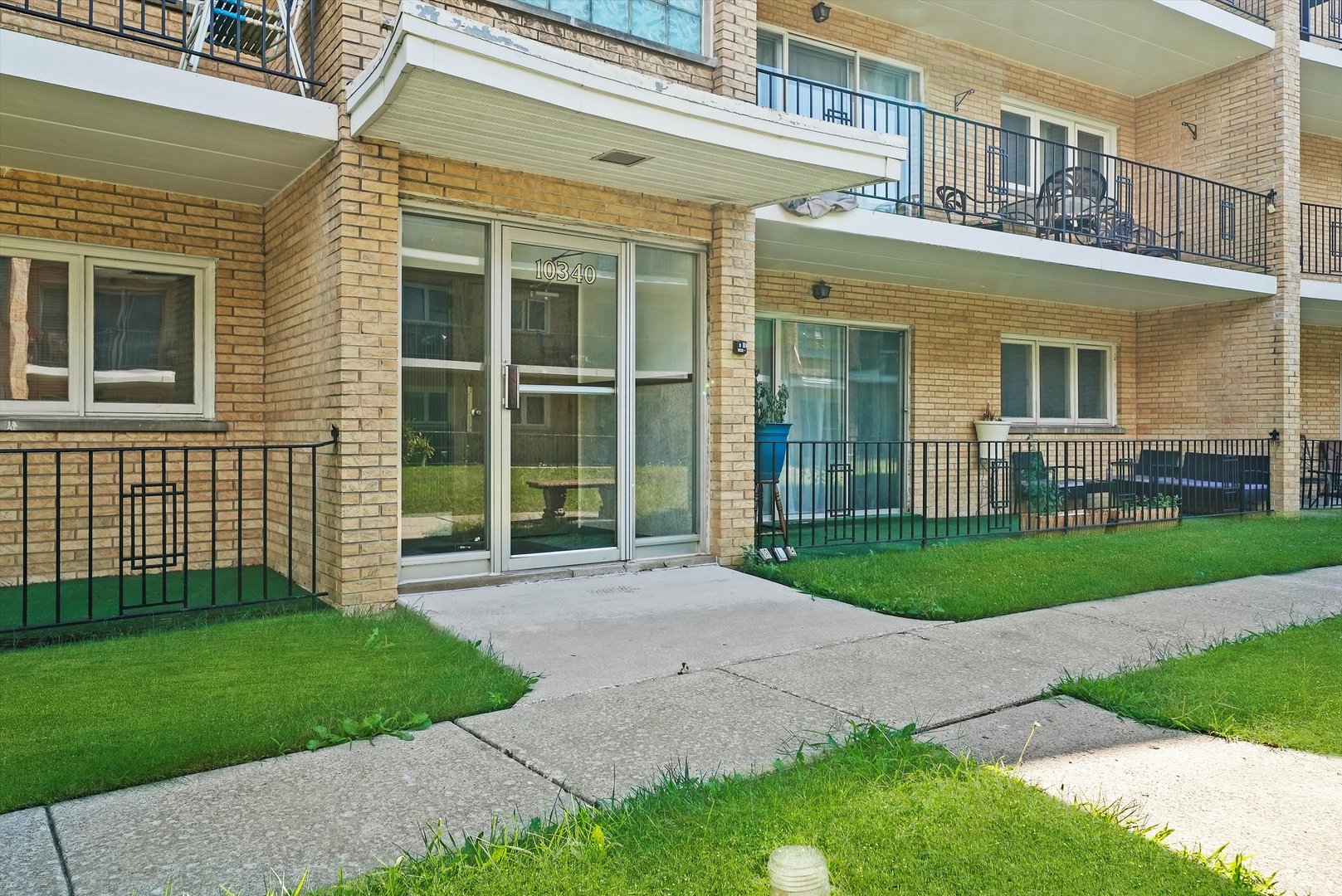 10340 South Pulaski Road, Unit 103 Oak Lawn, IL 60453 - Photo 30 of 30 front view of a brick house with a yard