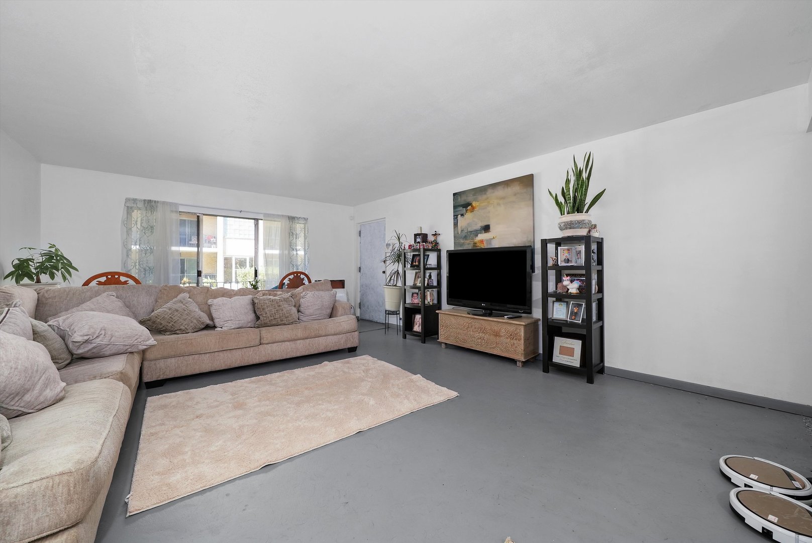 10340 South Pulaski Road, Unit 103 Oak Lawn, IL 60453 - Photo 3 of 30 a living room with furniture and a flat screen tv