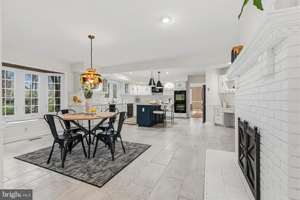 a large kitchen with stainless steel appliances granite countertop a stove and cabinets