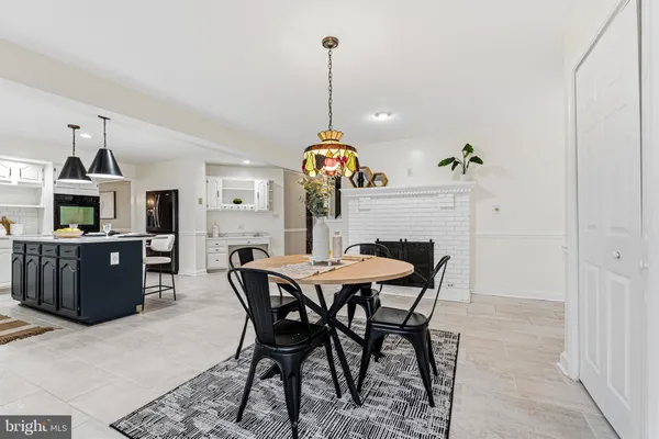 a large kitchen with a table and chairs in it