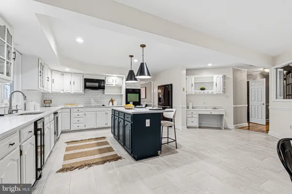 a kitchen with stainless steel appliances granite countertop a sink and a wooden cabinets