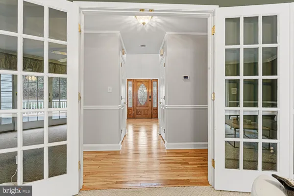 a living room with furniture a table and wooden floor
