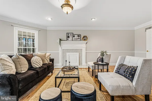a living room with furniture fireplace and window