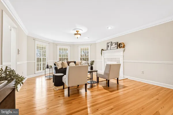 a living room with furniture a fireplace and a large window