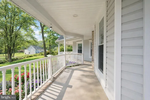 a view of a porch with wooden floor and fence