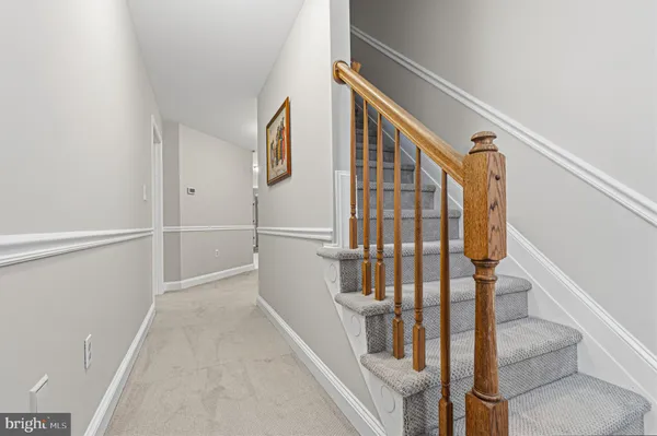 a picture of a white room with a white wall and a large window