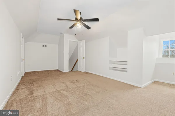 a picture of a room with a white wall and a window