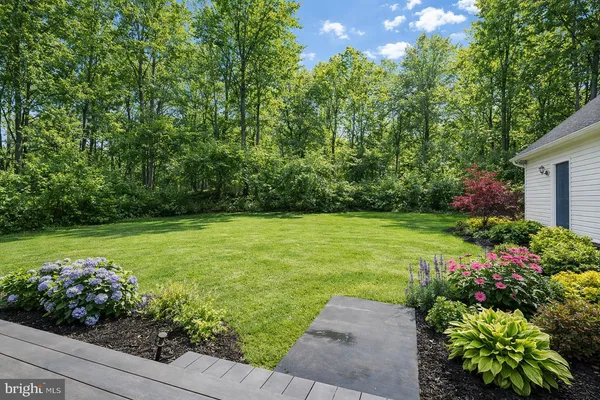 a front view of a house with a yard and trees