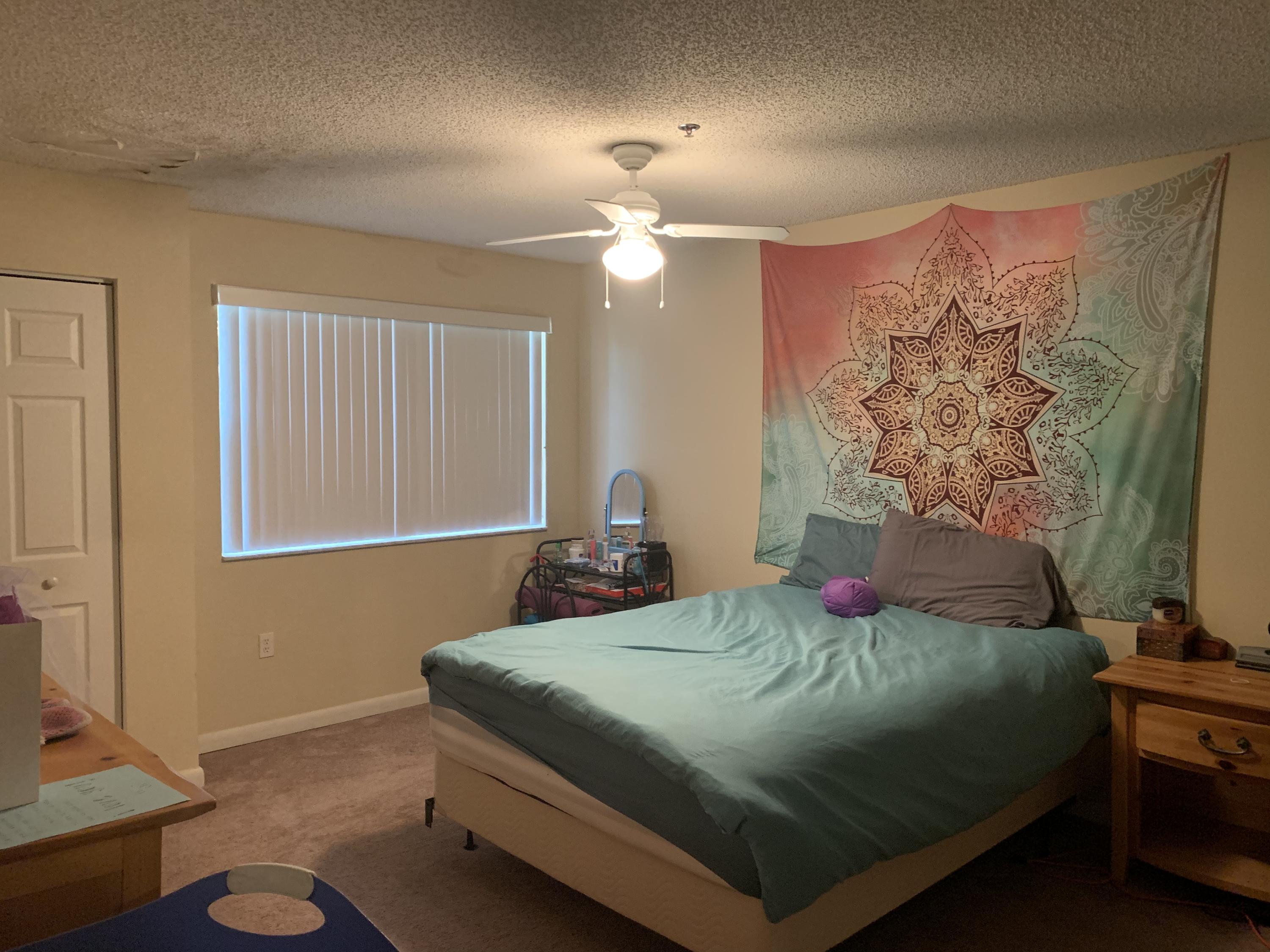 3279 Clint Moore Road, Unit 201 Boca Raton, FL 33496 - Photo 13 of 27 a bedroom with a bed and a chandelier