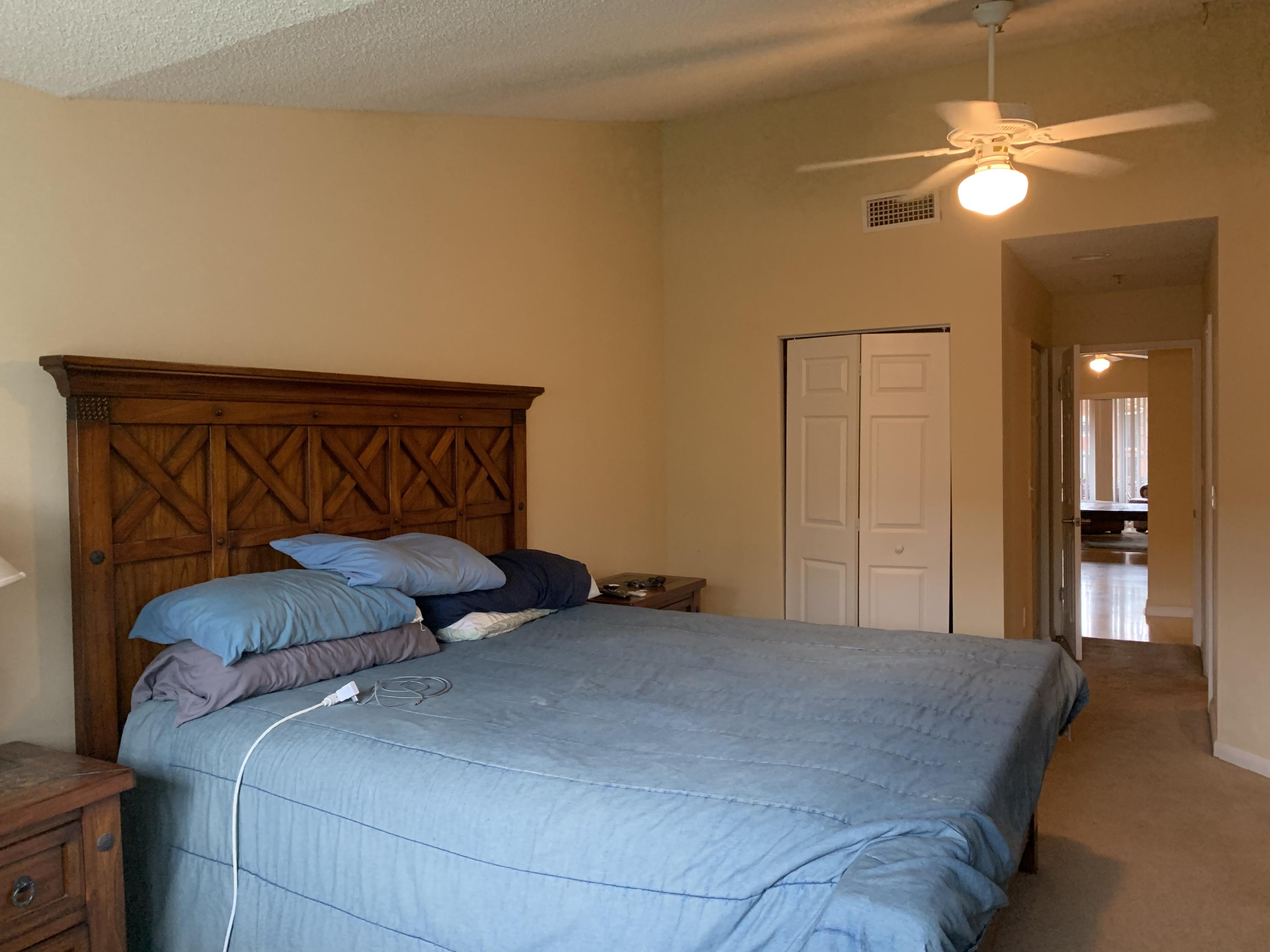 3279 Clint Moore Road, Unit 201 Boca Raton, FL 33496 - Photo 14 of 27 a bedroom with a bed and a chandelier