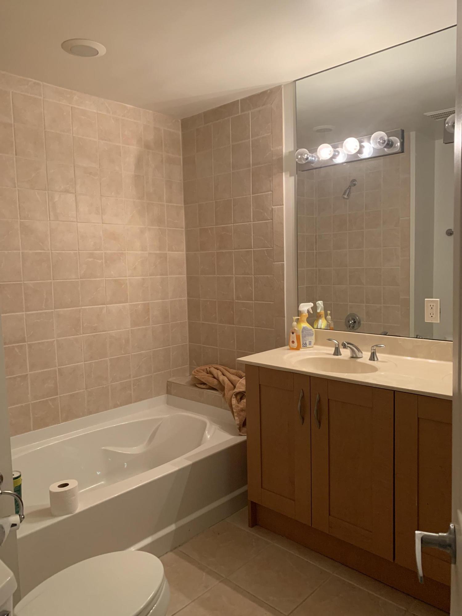 3279 Clint Moore Road, Unit 201 Boca Raton, FL 33496 - Photo 17 of 27 a bathroom with a sink mirror toilet and bathtub