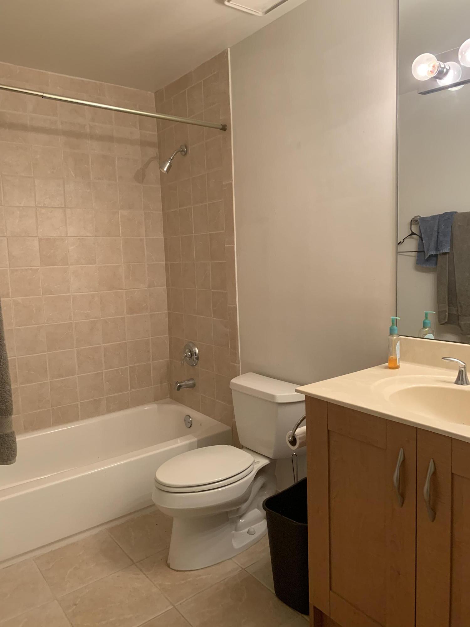 3279 Clint Moore Road, Unit 201 Boca Raton, FL 33496 - Photo 18 of 27 a bathroom with a toilet a sink and a bathtub