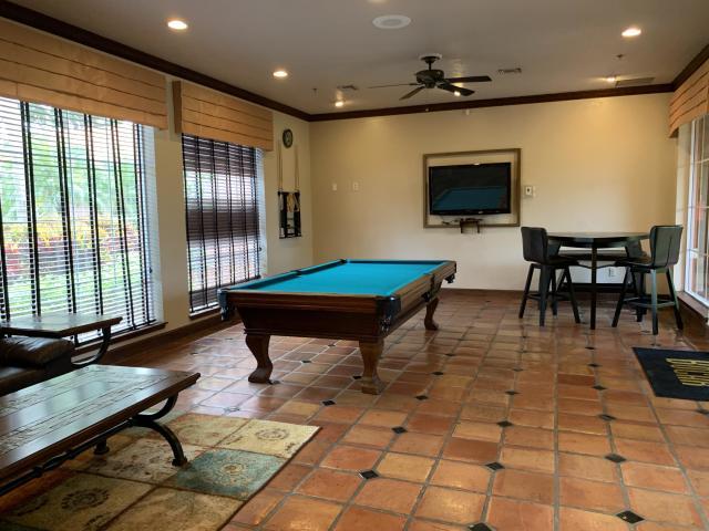 3279 Clint Moore Road, Unit 201 Boca Raton, FL 33496 - Photo 23 of 27 a living room with pool table and a flat screen tv