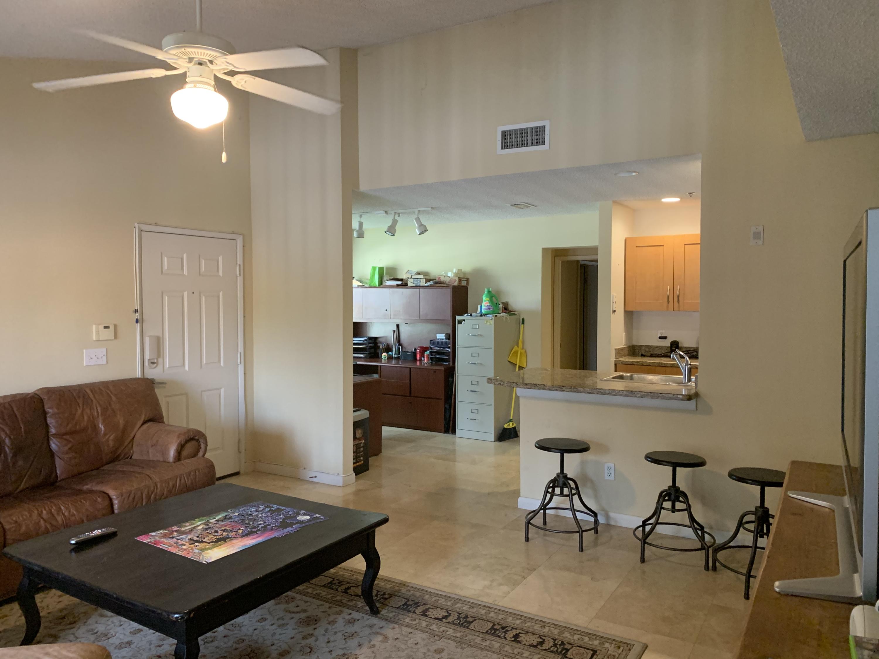 3279 Clint Moore Road, Unit 201 Boca Raton, FL 33496 - Photo 9 of 27 a living room with furniture and a couch