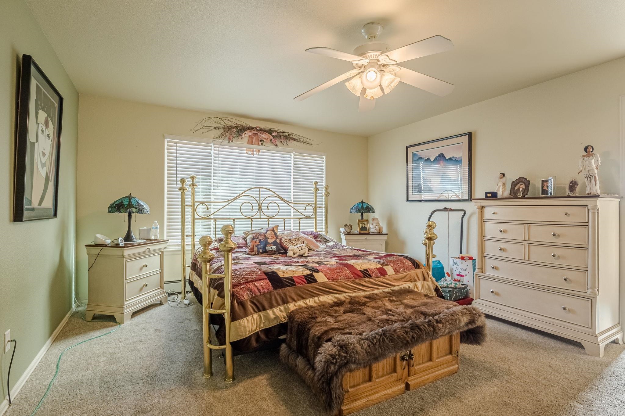 3153 Forrest Way Grand Junction, CO 81504 - Photo 16 of 42 a bedroom with a bed and a table