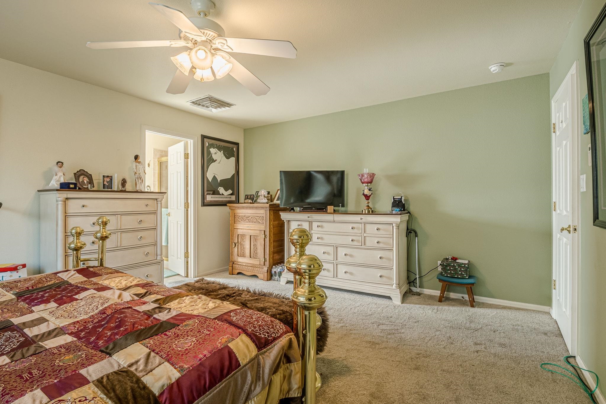 3153 Forrest Way Grand Junction, CO 81504 - Photo 17 of 42 a bedroom with a bed and flat screen tv