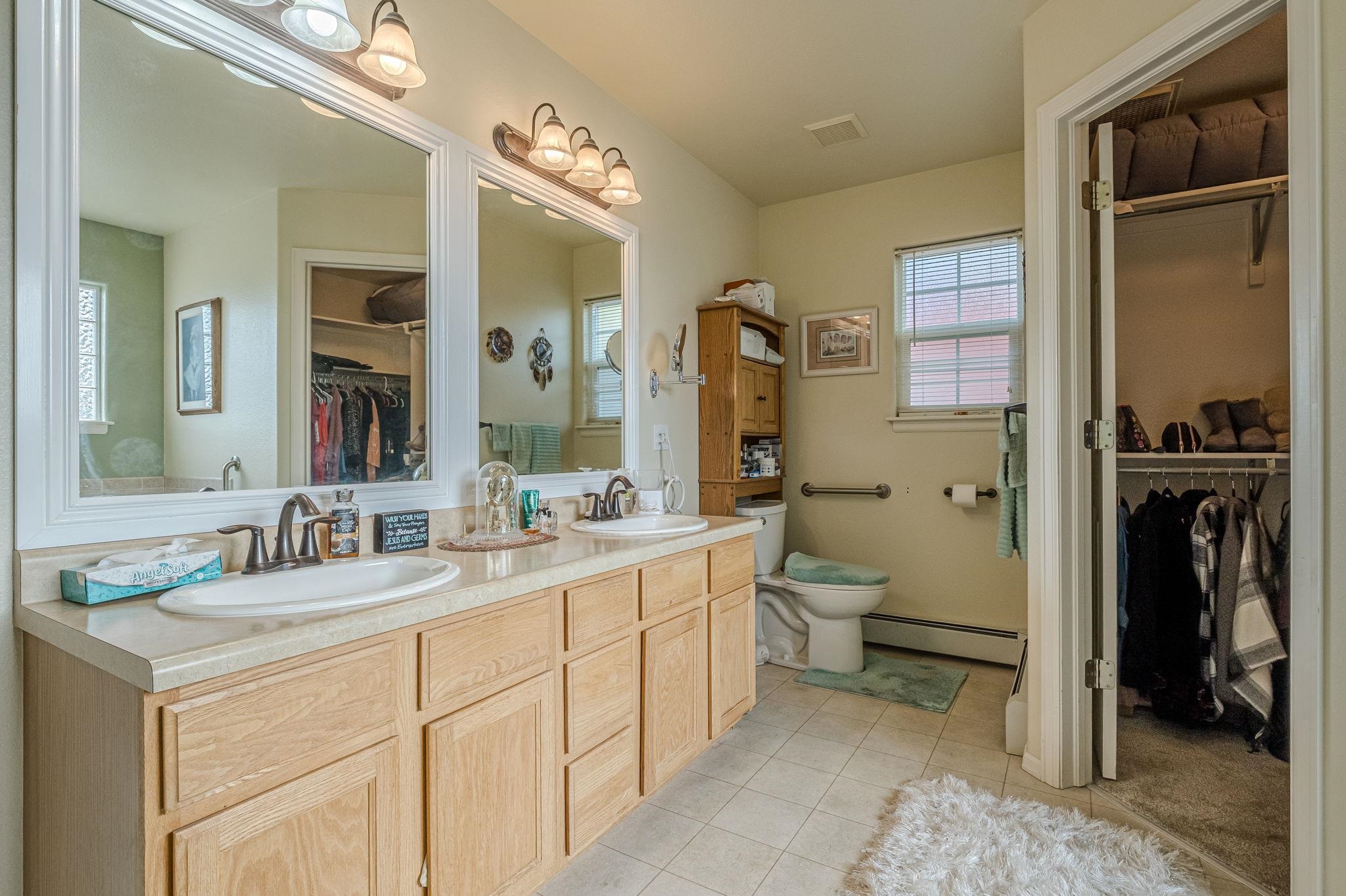 3153 Forrest Way Grand Junction, CO 81504 - Photo 21 of 42 a bathroom with a double vanity sink and a mirror