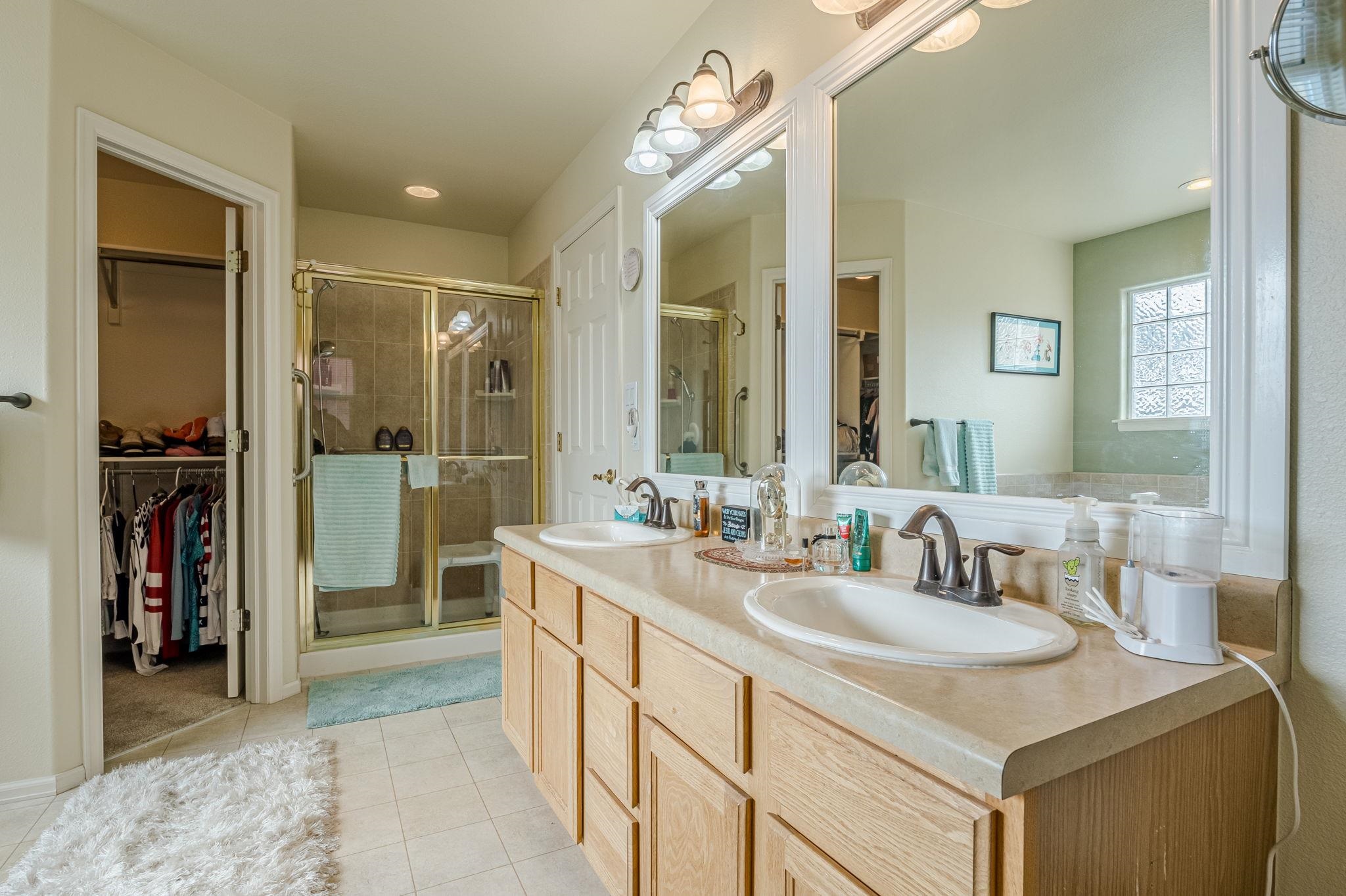 3153 Forrest Way Grand Junction, CO 81504 - Photo 22 of 42 a bathroom with a sink double vanity and a mirror