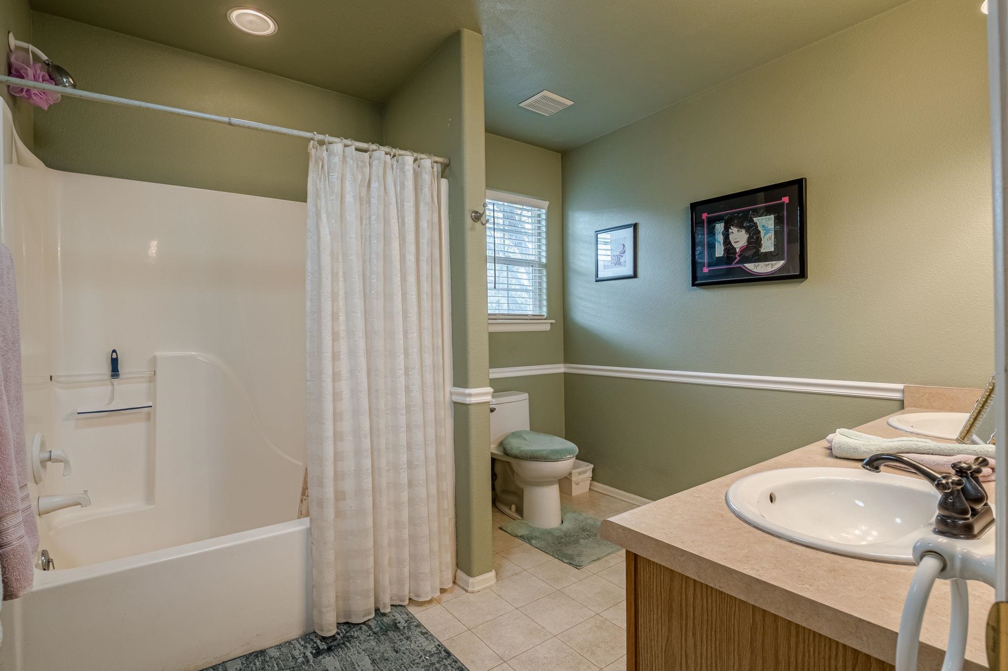 3153 Forrest Way Grand Junction, CO 81504 - Photo 27 of 42 a bathroom with a sink a toilet and shower