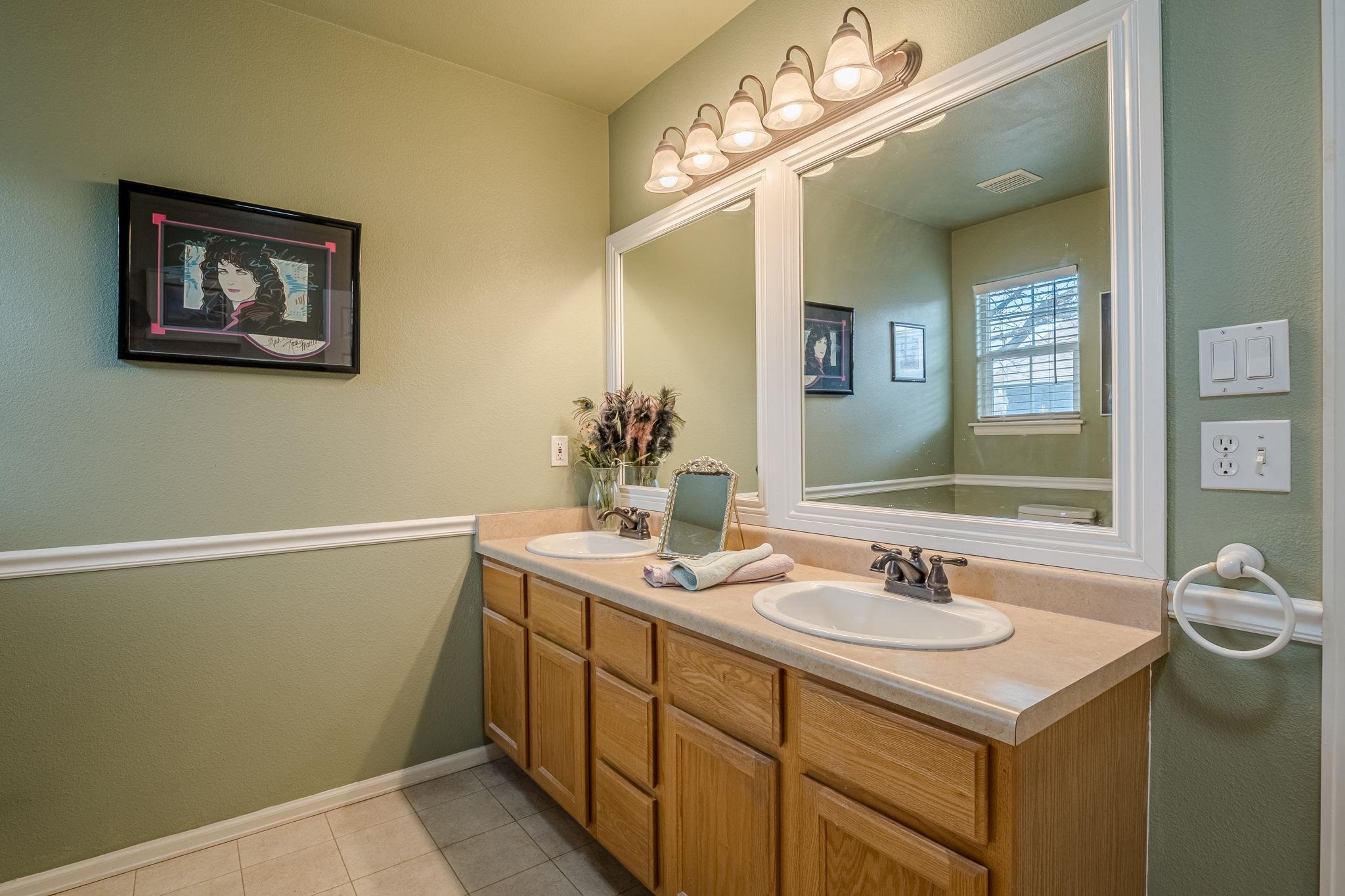 3153 Forrest Way Grand Junction, CO 81504 - Photo 28 of 42 a bathroom with a sink and a mirror
