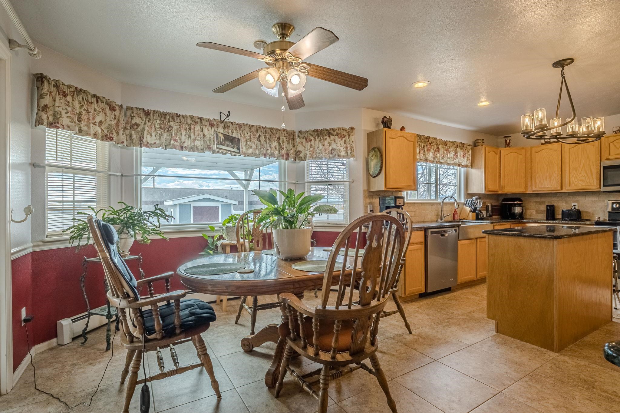 3153 Forrest Way Grand Junction, CO 81504 - Photo 6 of 42 a view of a dining room with furniture and chandelier