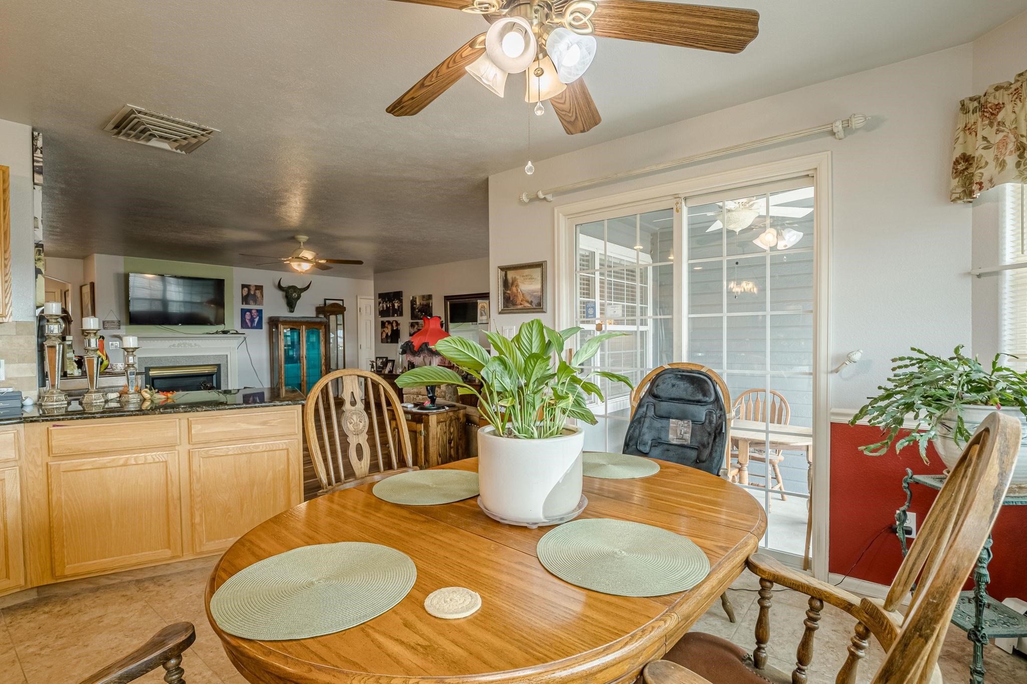 3153 Forrest Way Grand Junction, CO 81504 - Photo 8 of 42 a view of a dining room with furniture a chandelier and wooden floor