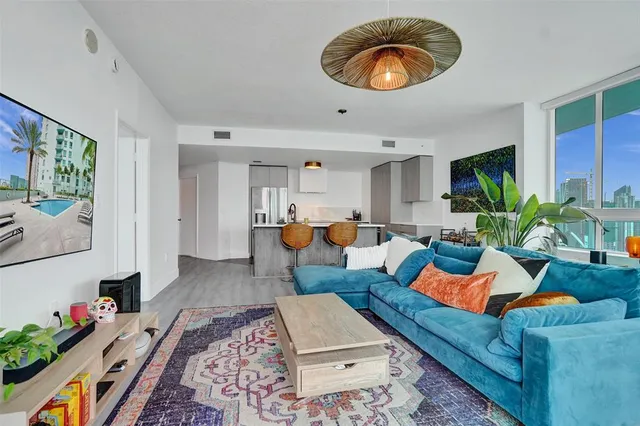 a living room with furniture and wooden floor