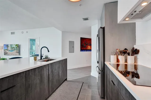 a kitchen with stainless steel appliances granite countertop a sink and cabinets