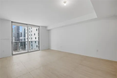 a view of an empty room with sliding glass door