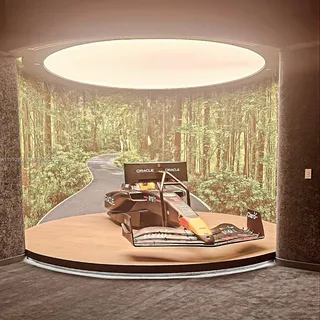 a living room with fireplace furniture and a large window