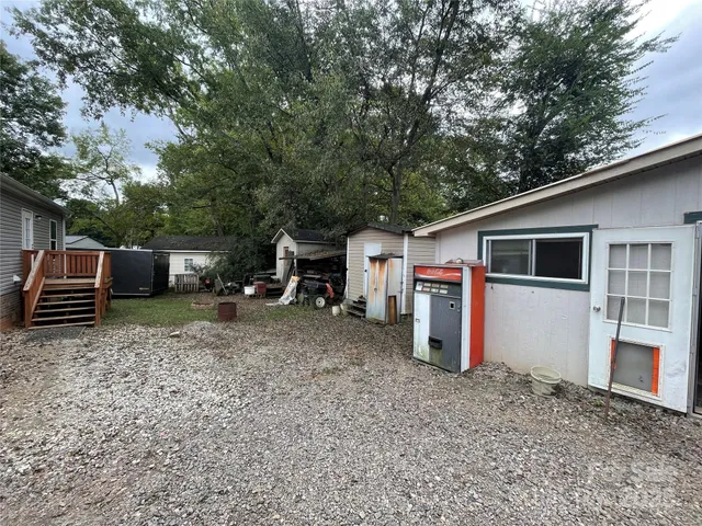 a view of a house with a backyard space and a tree