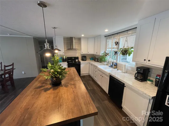 a kitchen with sink a microwave and cabinets